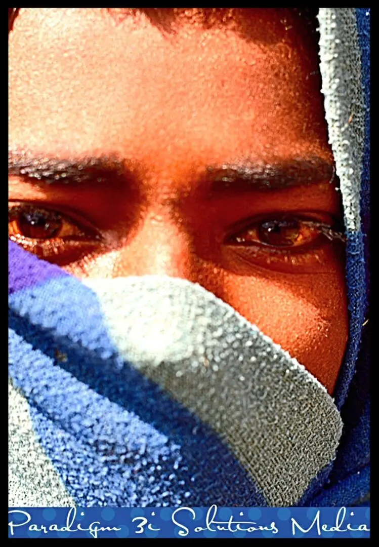 closeup shot of a teenage boy covered his mouth with scarf